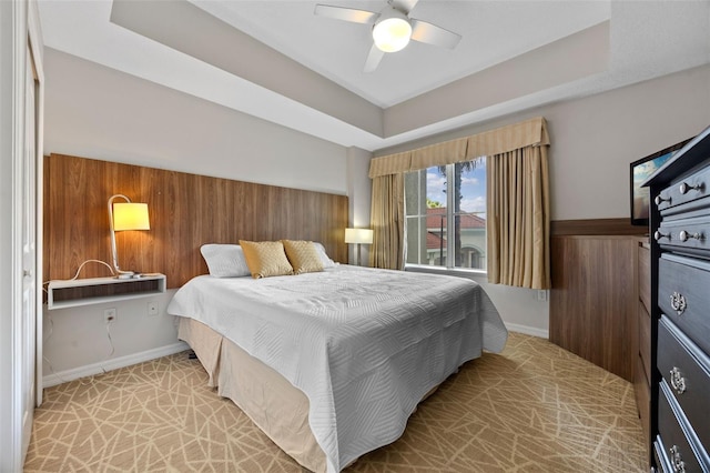 7395 Universal Blvd Unit 203, Orlando, FL 32819 - bedroom with a ceiling fan, light carpet, baseboards, and a raised ceiling