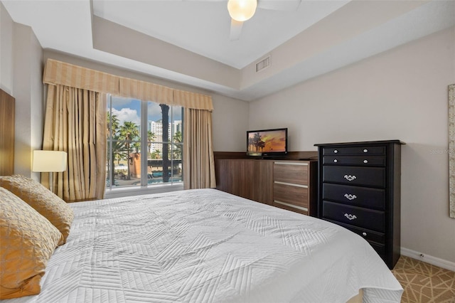 7395 Universal Blvd Unit 203, Orlando, FL 32819 - bedroom featuring visible vents, baseboards, a raised ceiling, and ceiling fan
