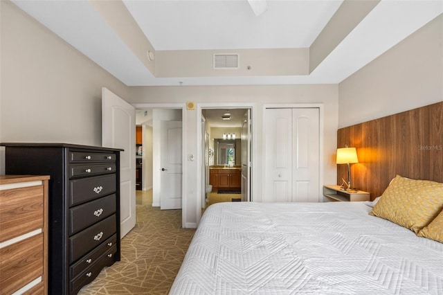 7395 Universal Blvd Unit 203, Orlando, FL 32819 - bedroom featuring ensuite bath, a closet, and visible vents