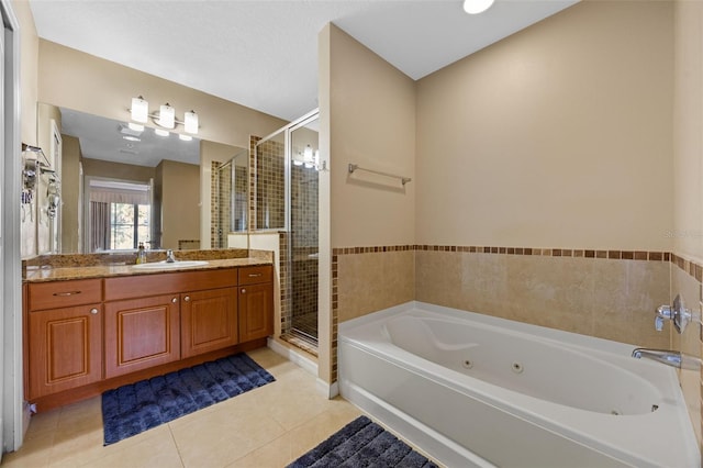 7395 Universal Blvd Unit 203, Orlando, FL 32819 - bathroom featuring a stall shower, tile patterned floors, vanity, and a whirlpool tub