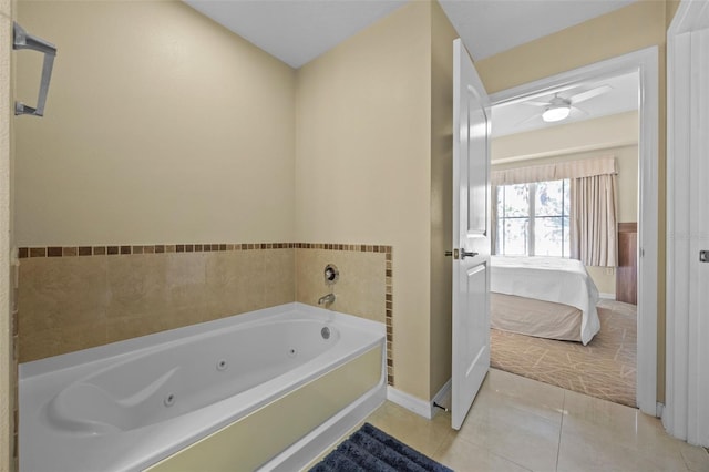 7395 Universal Blvd Unit 203, Orlando, FL 32819 - bathroom with baseboards, ensuite bath, ceiling fan, tile patterned flooring, and a jetted tub