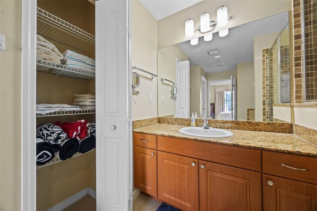 7395 Universal Blvd Unit 203, Orlando, FL 32819 - full bathroom featuring tile patterned floors, vanity, visible vents, and a walk in closet