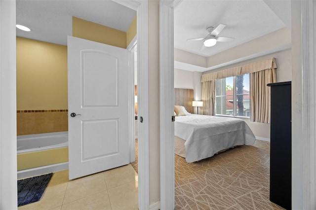 7395 Universal Blvd Unit 203, Orlando, FL 32819 - tiled bedroom featuring baseboards and a ceiling fan