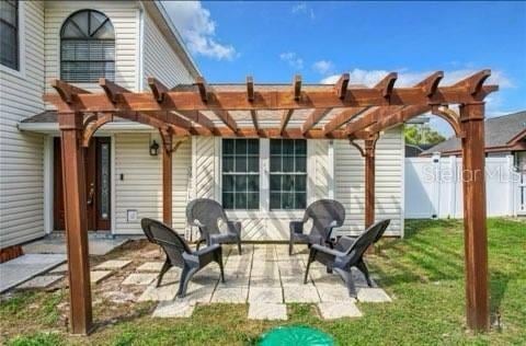 view of patio / terrace featuring fence and a pergola