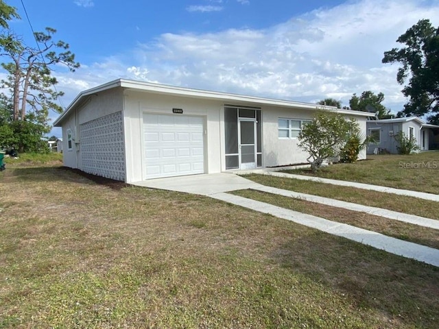 22011 Catherine Ave, Port Charlotte, FL 33952 - ranch-style house featuring a garage, stucco siding, concrete driveway, and a front lawn