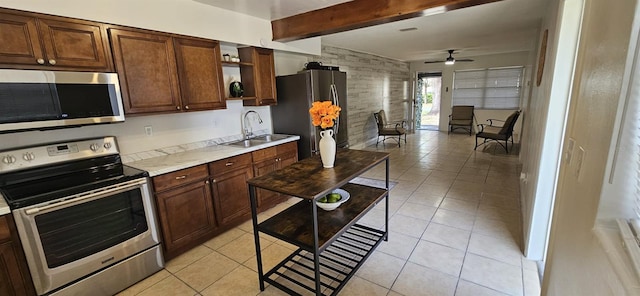 kitchen featuring a ceiling fan, appliances with stainless steel finishes, open shelves, a sink, and beamed ceiling