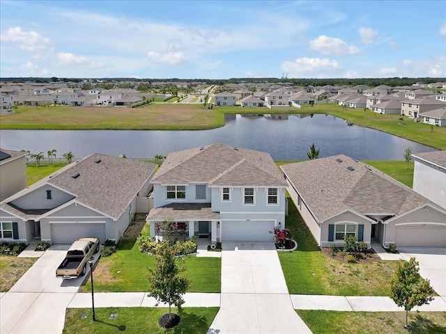 birds eye view of property featuring a water view and a residential view