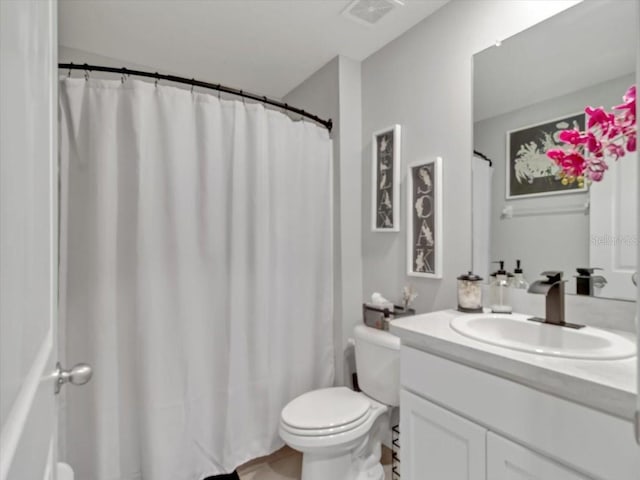 full bath with vanity, toilet, and visible vents