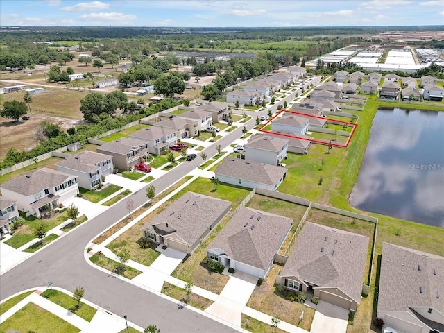 birds eye view of property with a water view and a residential view