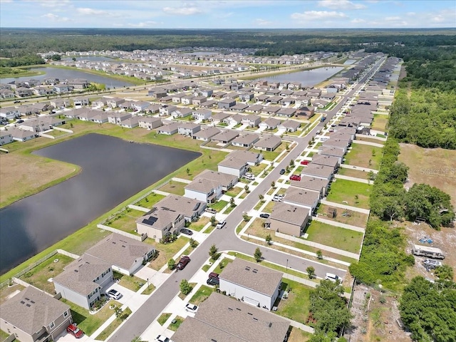 drone / aerial view with a water view and a residential view
