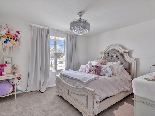 5289 Fiddle Fig Ave, Wimauma, FL 33598 - bedroom with light carpet and a chandelier