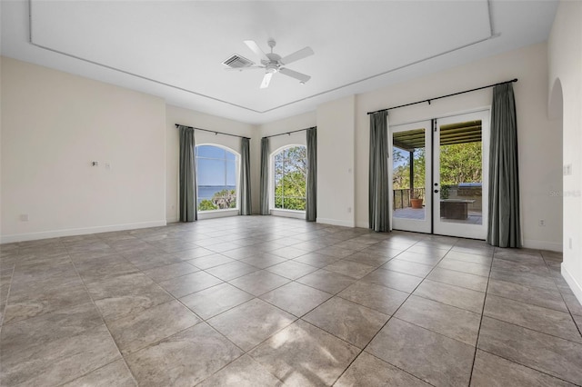spare room with tile patterned floors, french doors, a ceiling fan, baseboards, and visible vents