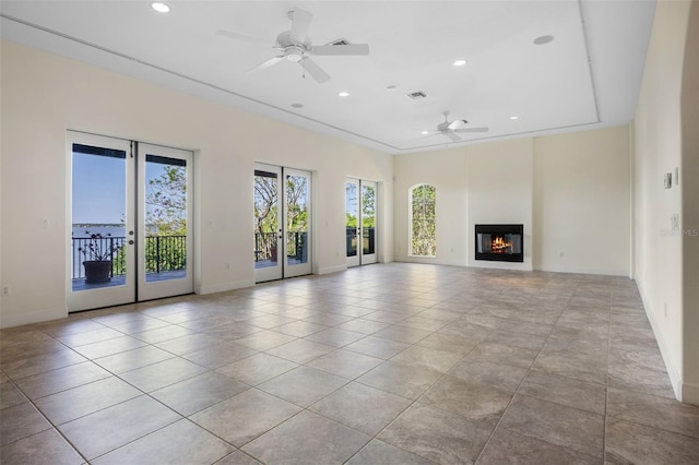 unfurnished living room with recessed lighting, ceiling fan, and baseboards