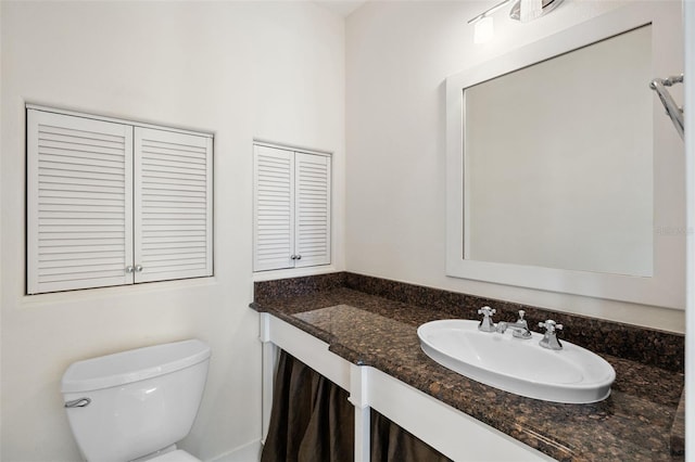bathroom featuring vanity and toilet