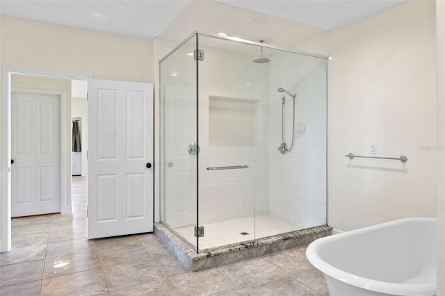 full bathroom with a freestanding tub and a shower stall