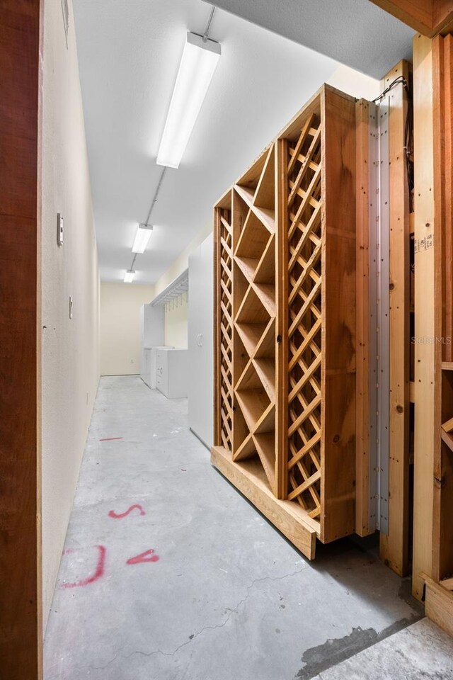 wine room featuring unfinished concrete flooring