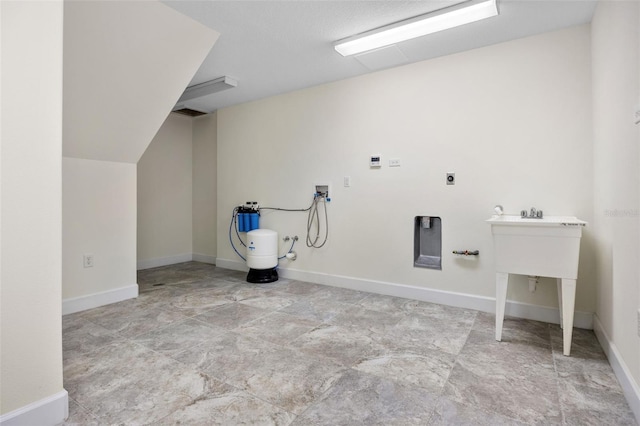 clothes washing area featuring laundry area, baseboards, and hookup for a washing machine