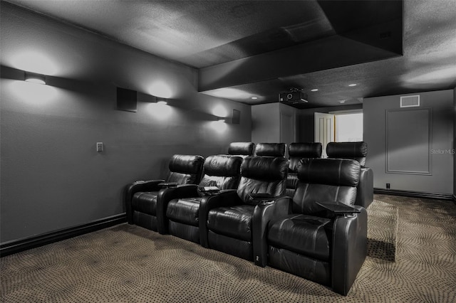 carpeted home theater featuring baseboards, a textured ceiling, and visible vents