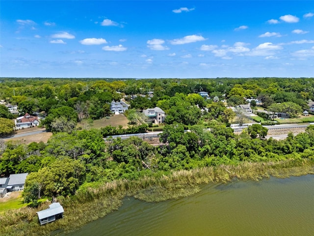 aerial view featuring a forest view and a water view