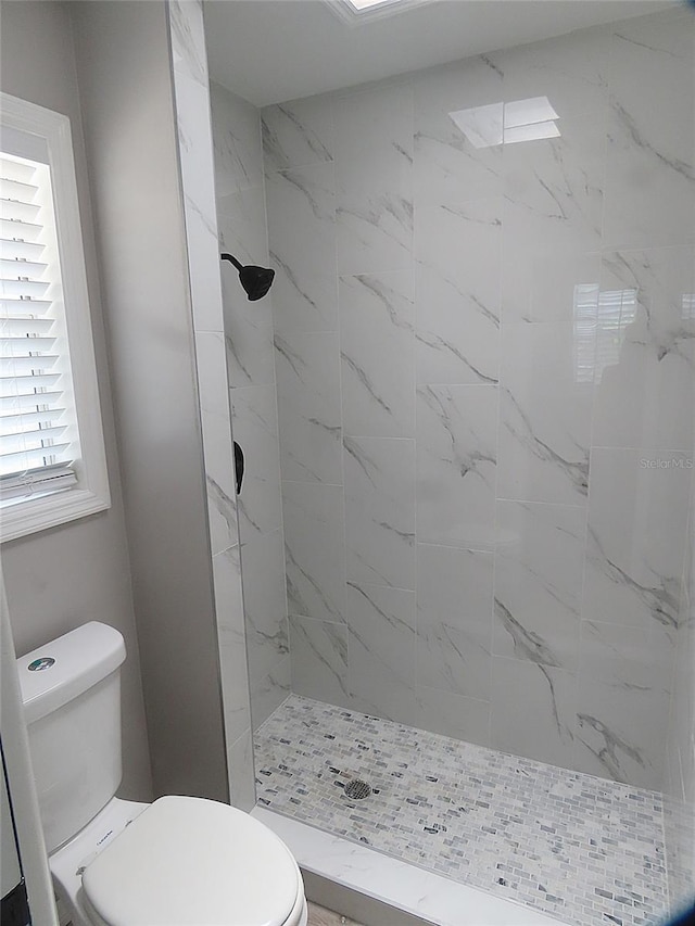full bathroom with toilet and tiled shower