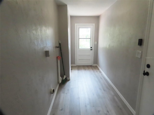 entryway with baseboards and light wood finished floors