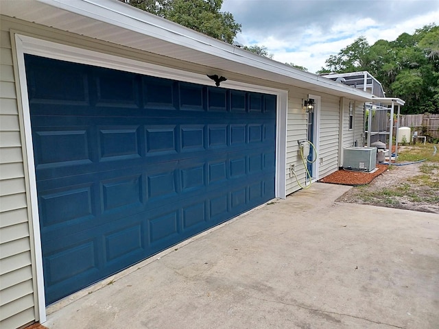 garage featuring concrete driveway