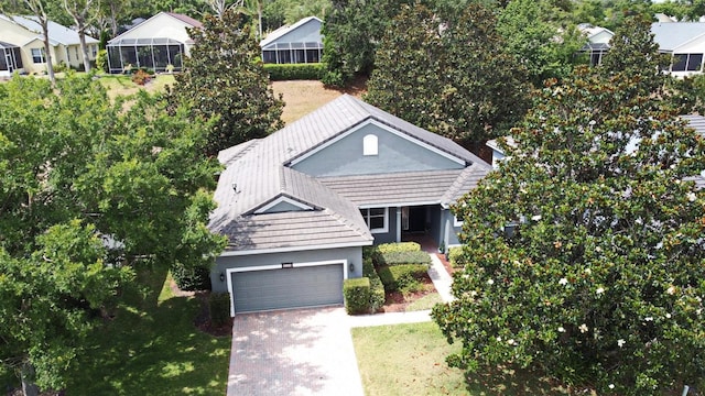 view of front of house featuring an attached garage, driveway, stucco siding, and a front yard