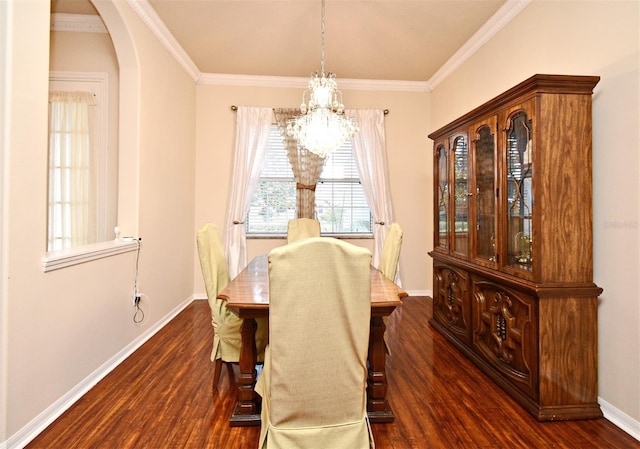 dining space with a chandelier, dark wood-style flooring, baseboards, arched walkways, and ornamental molding