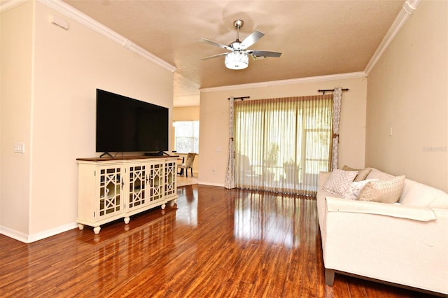 living area with a ceiling fan, ornamental molding, wood finished floors, and baseboards