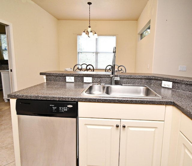 kitchen with stainless steel dishwasher, a sink, dark countertops, and a chandelier