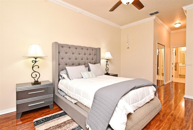 bedroom with dark wood finished floors, ornamental molding, baseboards, and a ceiling fan