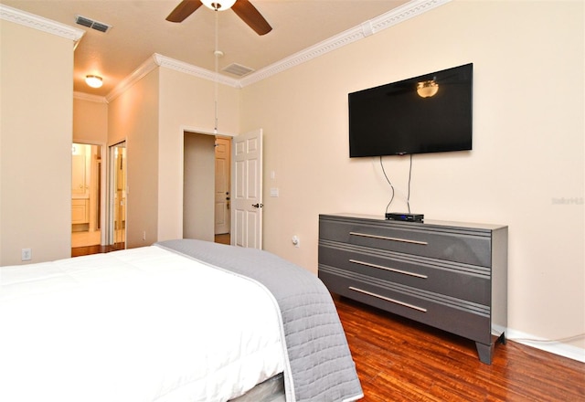 bedroom with crown molding, dark wood finished floors, connected bathroom, and ceiling fan