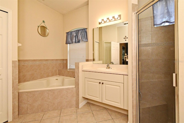 bathroom with tile patterned floors, a stall shower, a bath, and vanity