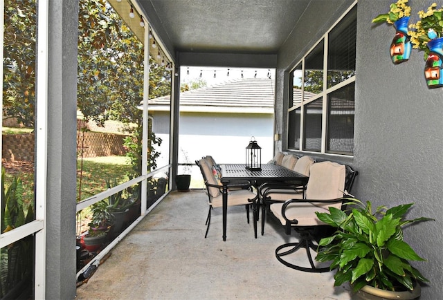 sunroom featuring outdoor dining area