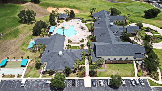 view of property location featuring a pool area and a golf course