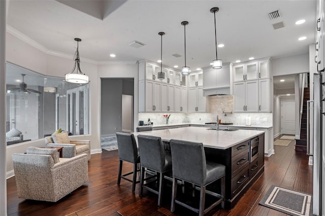 5108 Sailwind Cir, Orlando, FL 32810 - kitchen with a ceiling fan, white cabinets, stainless steel microwave, glass insert cabinets, and recessed lighting