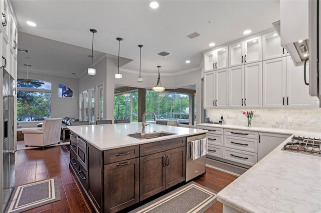 5108 Sailwind Cir, Orlando, FL 32810 - kitchen featuring a sink, appliances with stainless steel finishes, white cabinetry, dark brown cabinets, and crown molding