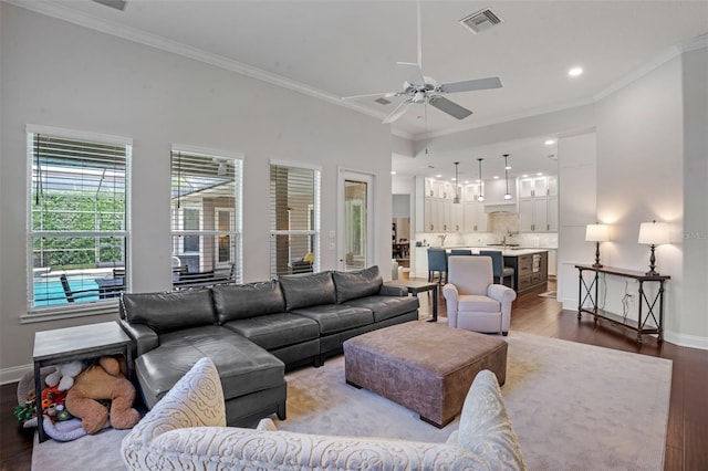 5108 Sailwind Cir, Orlando, FL 32810 - living room with dark wood-type flooring, baseboards, a ceiling fan, crown molding, and recessed lighting