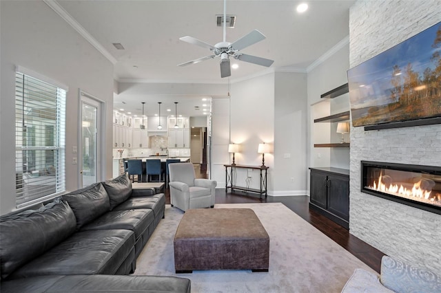 5108 Sailwind Cir, Orlando, FL 32810 - living room featuring a fireplace, dark wood-type flooring, ceiling fan, crown molding, and recessed lighting