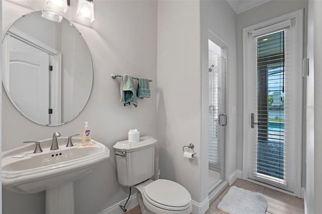 5108 Sailwind Cir, Orlando, FL 32810 - full bathroom featuring toilet, a shower stall, baseboards, and a sink