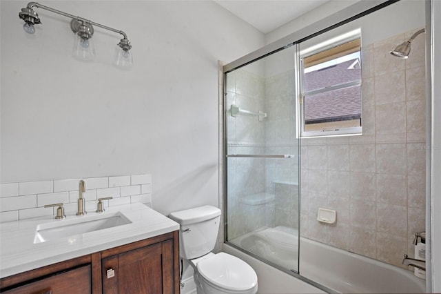 5108 Sailwind Cir, Orlando, FL 32810 - bathroom with toilet, shower / bath combination with glass door, vanity, and decorative backsplash