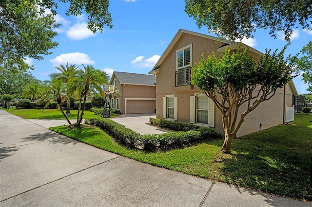 5108 Sailwind Cir, Orlando, FL 32810 - view of front facade featuring stucco siding, concrete driveway, a front lawn, and an attached garage