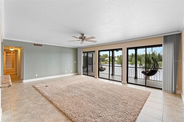 unfurnished living room with light tile patterned floors, crown molding, ceiling fan, and a textured ceiling