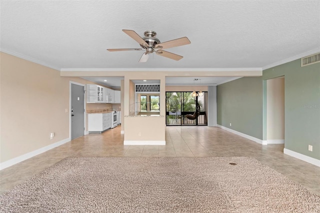unfurnished living room featuring a ceiling fan, a textured ceiling, visible vents, baseboards, and ornamental molding
