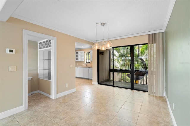 unfurnished dining area featuring light tile patterned floors, baseboards, crown molding, and a sink