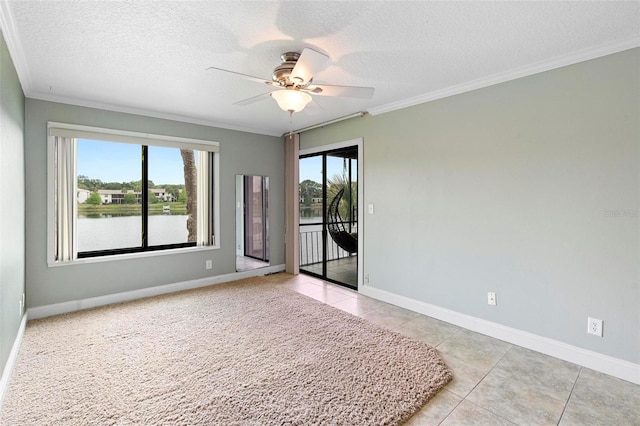 unfurnished room with a ceiling fan, ornamental molding, and a textured ceiling