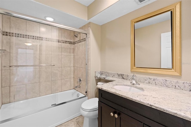 bathroom featuring toilet, tile patterned flooring, vanity, and combined bath / shower with glass door