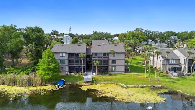 birds eye view of property featuring a water view and a residential view