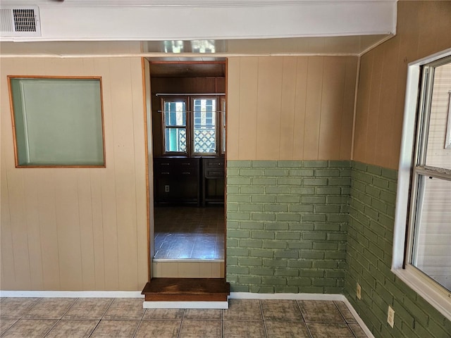 1424 Lake Shore Dr, Casselberry, FL 32707 - corridor featuring baseboards, wood walls, tile patterned floors, and visible vents