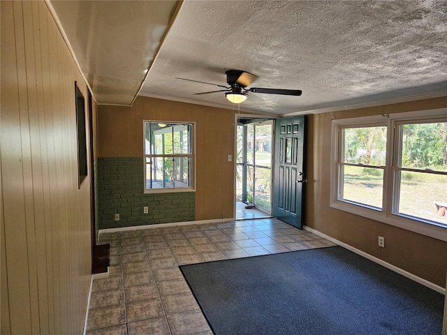 1424 Lake Shore Dr, Casselberry, FL 32707 - foyer featuring a ceiling fan, baseboards, ornamental molding, wooden walls, and tile patterned flooring